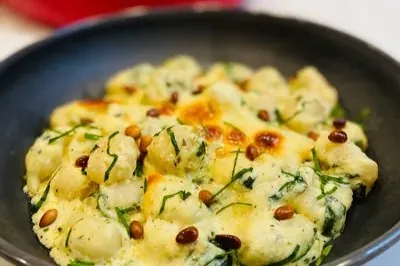 CHEESY BAKED GNOCCHI IN A PESTO CREAM SAUCE